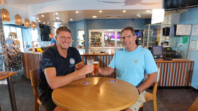 Surfers Paradise Surf Life Saving Club plans to reopen this Friday with a fresh look. Surfers SLSC President Trevor Hendy toasts the new renovations with Supporters Club president Jon Neilsen. Picture Glenn Hampson