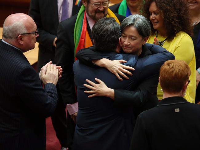 A very happy Dean Smith is embraced by Penny Wong. Picture Gary Ramage