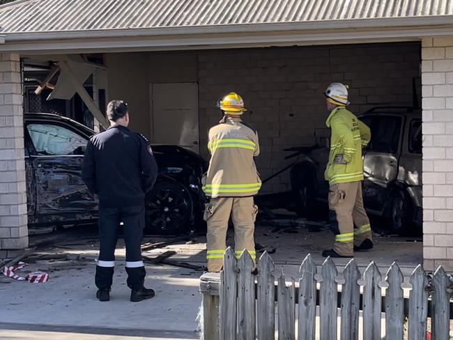 The black BMW smashed through a side fence and into the garage of the home, colliding with a parked car and injuring the home's owner.