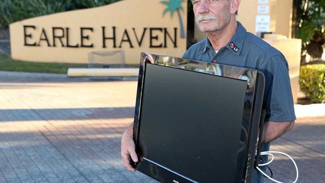 Lloyd Evans removes a TV that belongs to his mother from Earle Haven at Nerang. Picture Glenn Hampson. Picture: Glenn Hampson