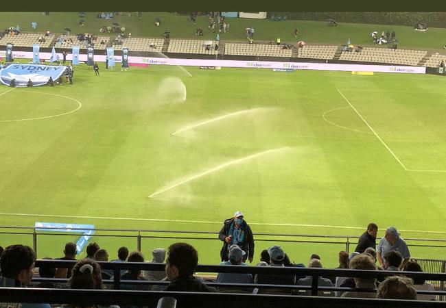 Sprinklers on at Kogarah before an A-League game after heavy rain.