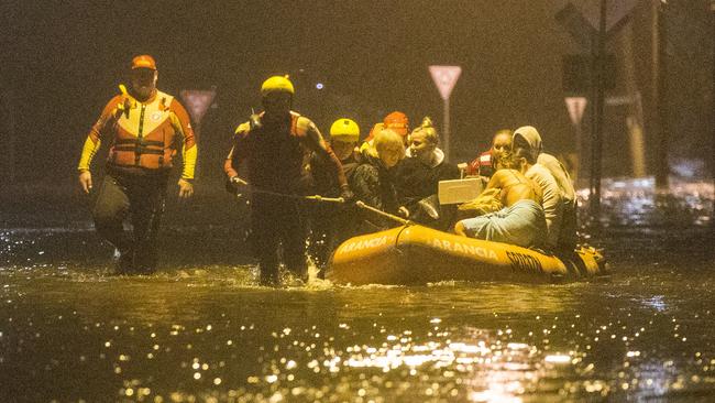 Carole Lloyd her grandson Dekota Davidson, Huana Cleaveland (holding cat pink shirt) Tia Grace (black top) and Malia Cleveland being evacuated by Surf Rescue from their home at 66 Mactier Street Narrabeen,  Narrabeen lagoon is flooding the area due to heavy rain. , Sydney. 9th February, 2020. Picture by Damian Shaw