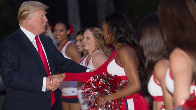 US President Donald Trump with cheerleaders from Florida Atlantic University. Picture: AFP.