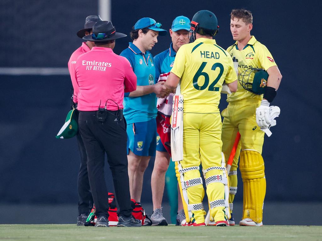 Australia's Travis Head (2nd R) receives medical treatment during the fourth one-day international (ODI) cricket match between South Africa and Australia at SuperSport Park in Centurion. Picture: AFP