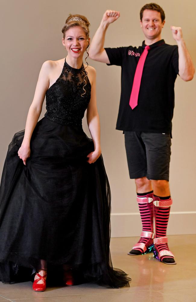 Mackenziee Lawler in her formal dress and shoes with physiotherapist Tim McGowen. Picture: John Gass