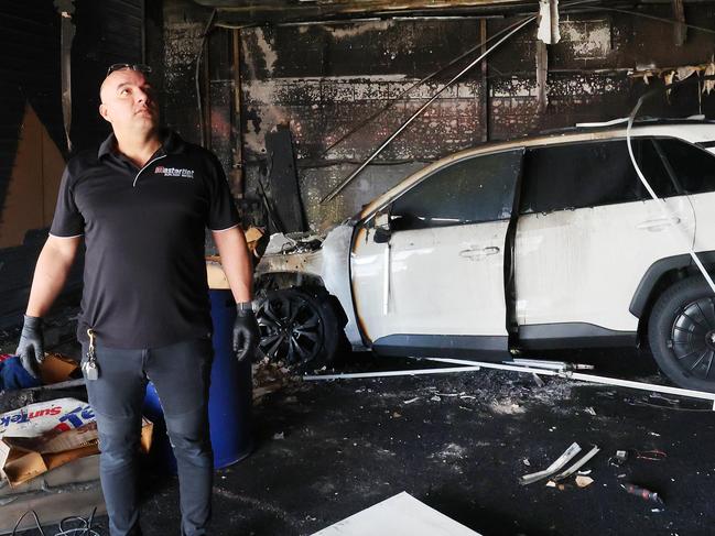 Mastertint at West Burleigh was significantly damaged in a fire yesterday, and police suspect arson. Business owner Jack Jenkins surveys the damage. Picture Glenn Hampson