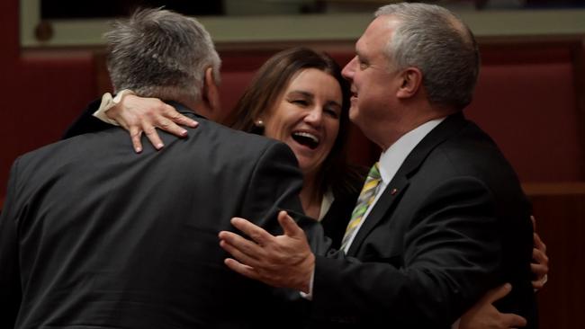 Senator Jacqui Lambie, centre, celebrates with Senator Stirling Griff and Senator Rex Patrick after tax cuts pass. Picture: Tracey Nearmy/Getty