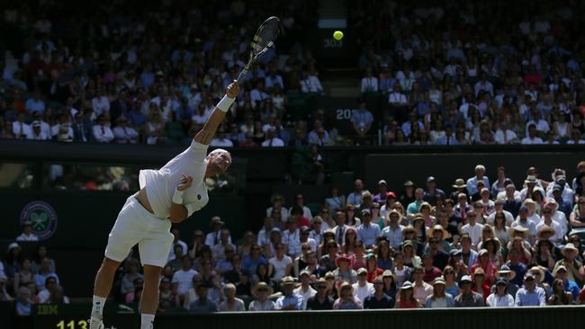 Sam Groth of Australia serves to Roger Federer.