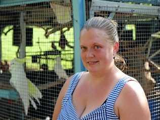 HELP NEEDED: Kirsty Lax, stands in front of a cage with several Sulphur Crested Cockatoos and macaws that she cares for. Picture: Dominic Elsome