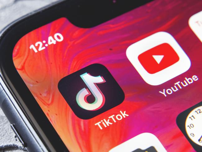 TikTok and YouTube apps on screen iphone xr, close up