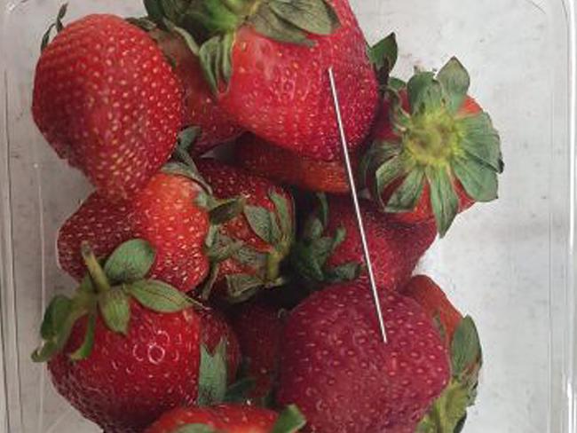 A thin piece of metal seen among a punnet of strawberries found in Queensland.