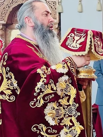 Father John Christodoulos with the communion chalice at St Andrew Parish. Picture: Supplied