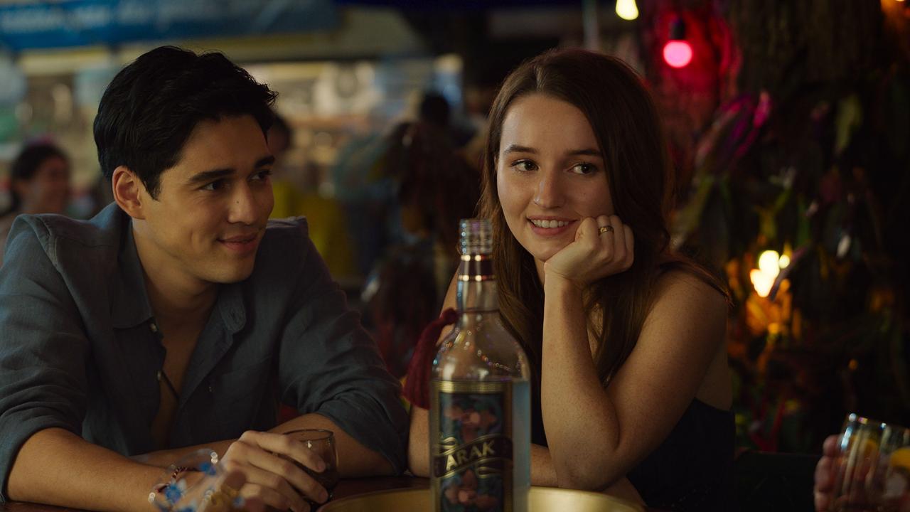 Characters Gede (Maxime Bouttier) and Lily (Kaitlyn Dever) in a scene filmed at the Carrara markets in Ticket to Paradise, directed by Ol Parker. Picture: Universal Pictures