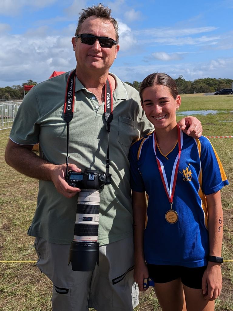 Sophia Jordan winning a medals at a sports event with her father, Andrew Jordan, supporting her.