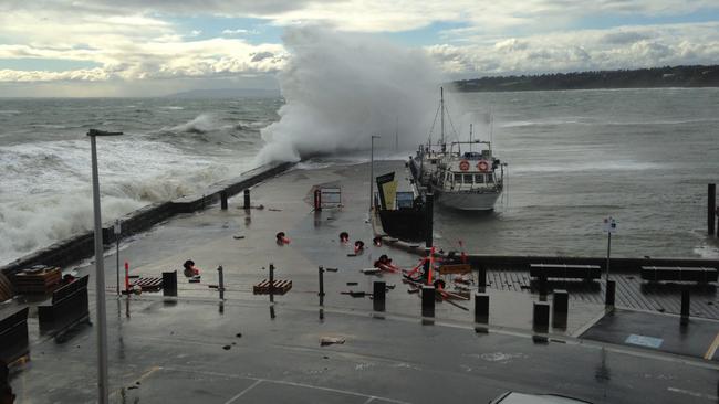 Waves crash over Mornington Pier today.