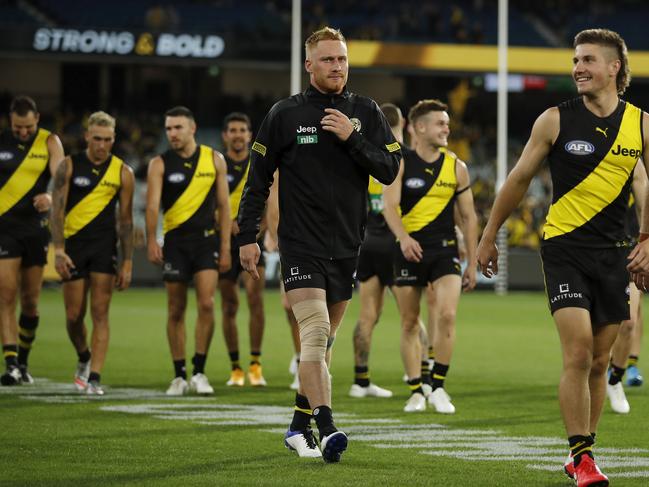 Nick Vlastuin of the Tigers leaves the field with a leg injury. (Photo by Dylan Burns/AFL Photos via Getty Images)