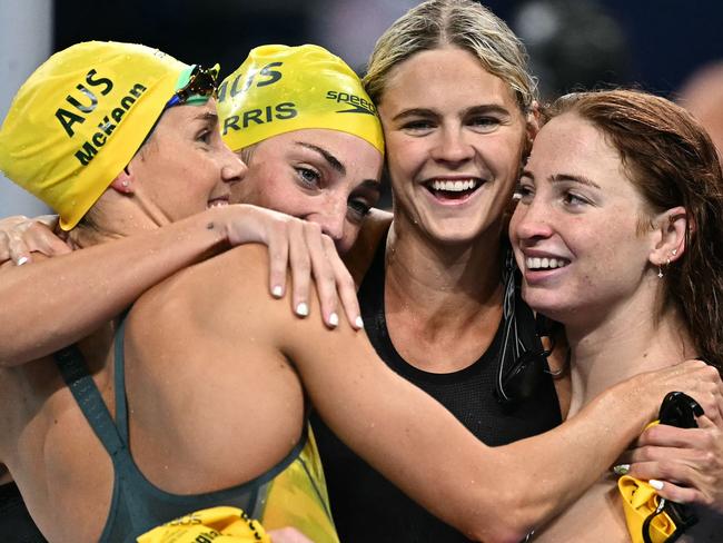 Gold medallists Australia's Emma Mckeon, Australia's Meg Harris, Australia's Shayna Jack and Australia's Mollie O'callaghan celebrate after competing in the final of the women's 4x100m freestyle relay swimming event at the Paris 2024 Olympic Games at the Paris La Defense Arena in Nanterre, west of Paris, on July 27, 2024. (Photo by Manan VATSYAYANA / AFP)