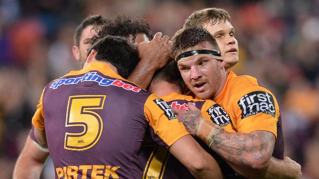 Ben Hunt of the Broncos celebrates with team mates after scoring.