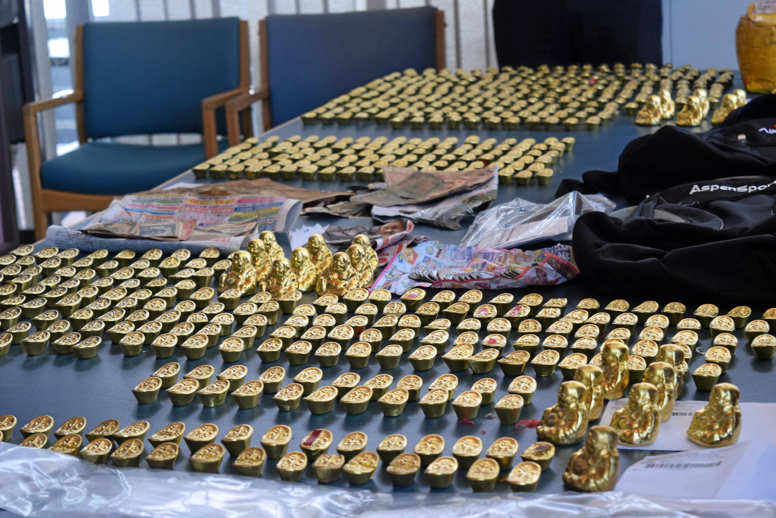 Fake gold Buddha statues and ingots seized by police are alleged to have been used to scam people. Picture: Chloe Lyons