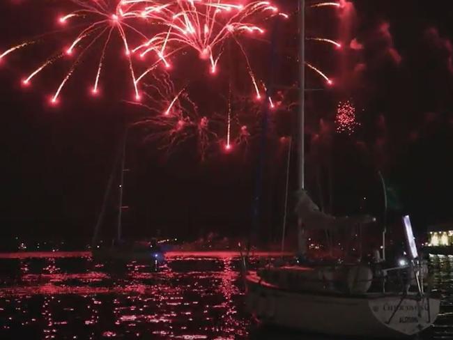 The final yacht in the Sydney to Hobart yacht race  Carrowong heads back to the docks as the fireworks light up the Hobart sky after finishing the race just before  midnight on New Year's Eve.Picture: Rolex Sydney Hobart Yacht Race