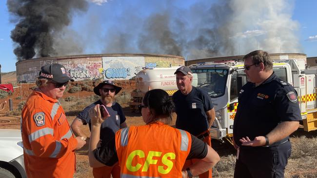 CFS crew discuss operations in 42C heat. Picture: Isaac Selby