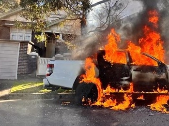 A car on fire after the nearby Marrickville shooting. Picture: Twitter