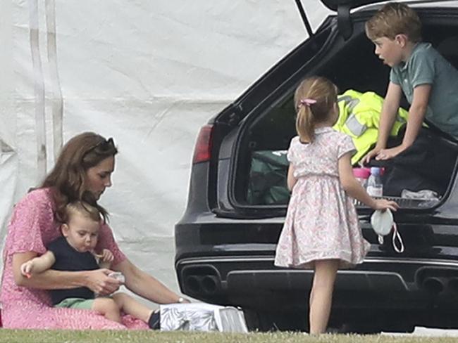 Britain's Kate The Duchess of Cambridge sits with Prince Louis, with Prince George, right, and Princess Charlotte during the King Power Royal Charity Polo Day at Billingbear Polo Club. Picture: AP