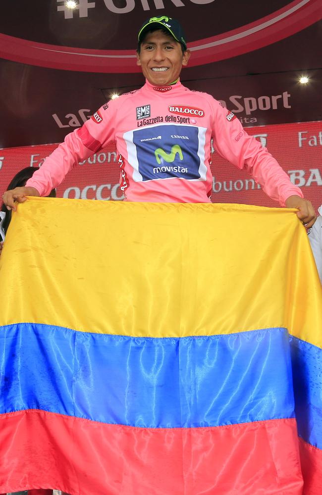 Colombian cyclist Nairo Quintana celebrates with the pink jersey and his nation’s flag.