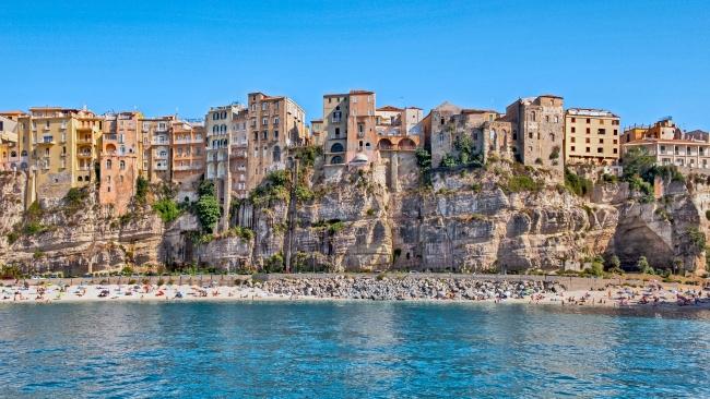 4/11Most beautiful village: Tropea  Taking home the title for Italy’s   “Borgo dei Borghi 2021” (most beautiful village), this coastal town in Calabria is known as the Pearl of the Tyrrhenian Sea. With its clifftop architecture, cobblestone streets and azure seas, Tropea in southern Italy lives up to the hype. Adding to the visual drama is Sanctuary of Santa Maria dell’Isola, an ancient monastery perched high on a rocky outcrop overlooking the ocean and accessible only by foot. Pay the small fee to visit the gardens. 