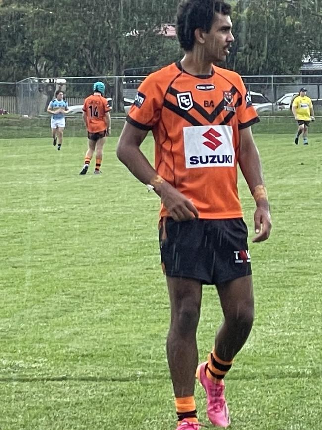 Summer rains fall on Joshua Donovan at Leo Williams Oval.