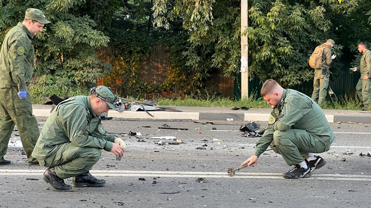 Russian investigators seen combing the scene on Sunday after an explosive device was planted on Dugin’s car. Picture: Handout / Investigative Committee of Russia / AFP