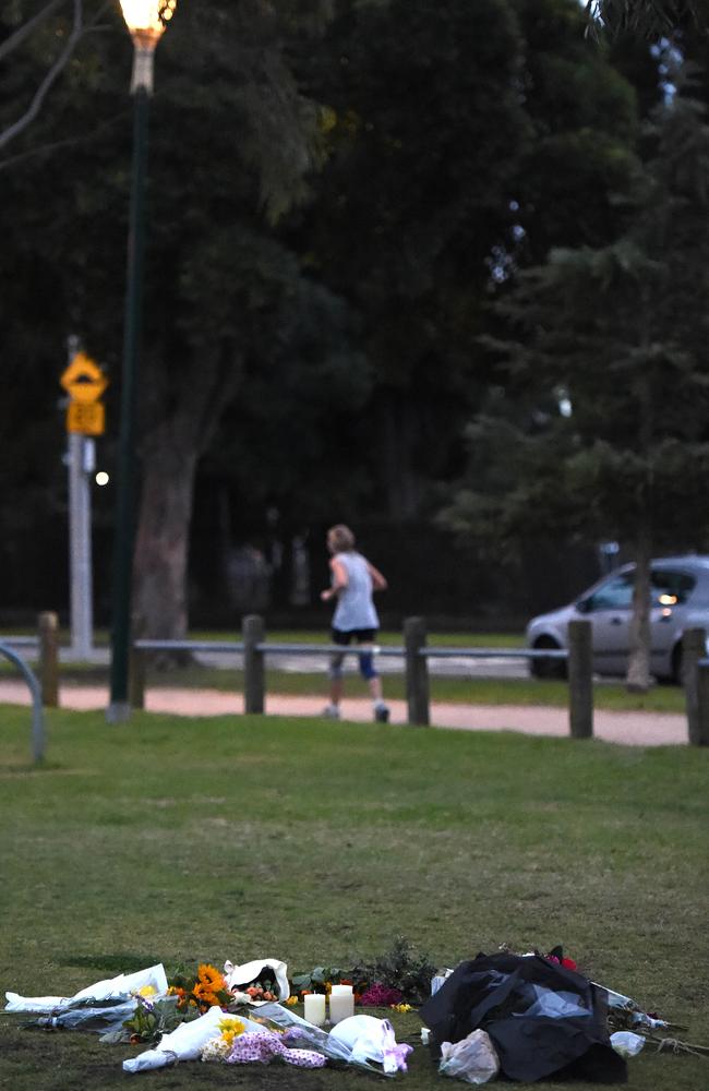 A jogger passes the floral tribute this morning. Picture: Nicole Garmston