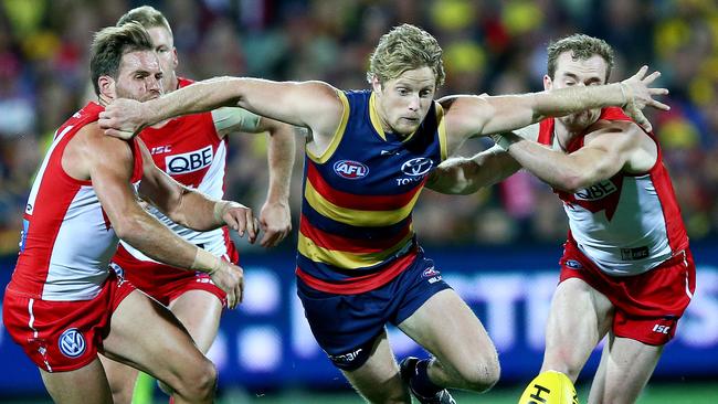 Rory Sloane holds off to Swans in the race for the ball. Picture: Sarah Reed