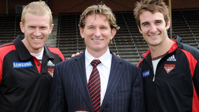 James Hird with Dustin Fletcher and Jobe Watson after being named Essendon coach in 2010.