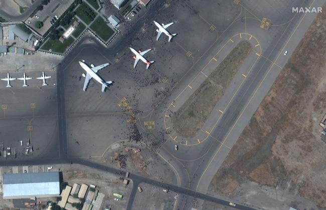 Crowds of people are seen from this satellite image above Kabul Airport. Picture: Maxar Technologies/AFP