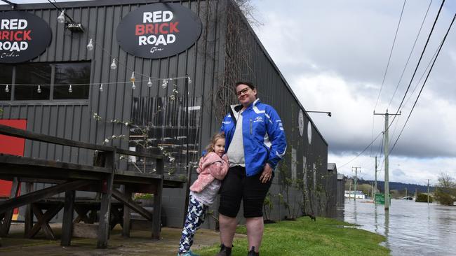 Karina Dambergs and daughter Beatrix watching the fort at their Red Brick Road Ciderworks. Tasmania floods 2022. Photo: Alex Treacy