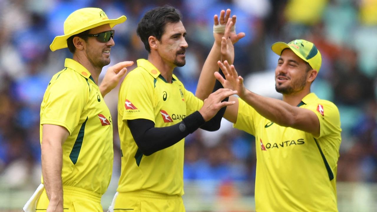 Australia's Mitchell Starc celebrates with teammates. Photo by Noah SEELAM / AFP