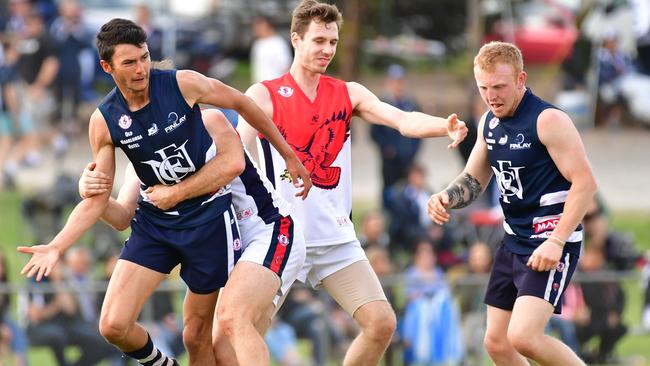 Noarlunga (navy) and Flagstaff Hill (red/white) players battle during the SFL grand final last year at Noarlunga Oval.                              Picture AAP/Keryn Stevens.