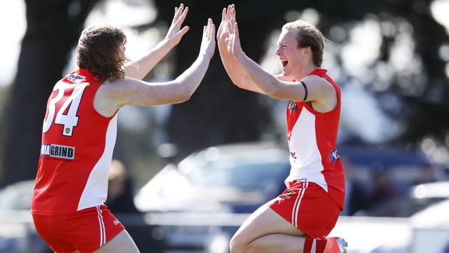 Clarence's James Holmes celebrates with brother Noah after kicking the opening goal of the game. Picture: ZAK SIMMONDS