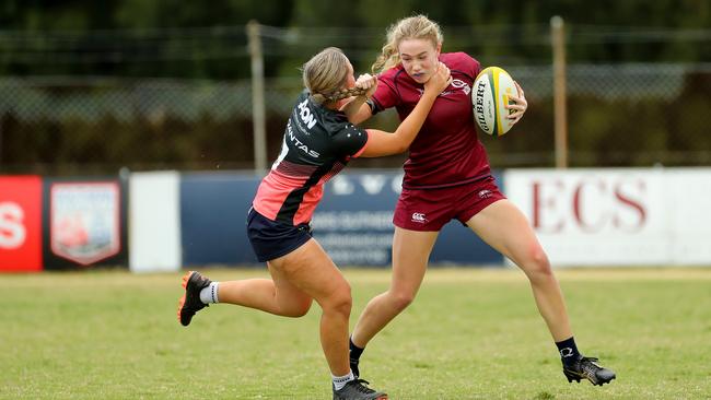 Lila Parr of Queensland fends off a Barbarian defender.