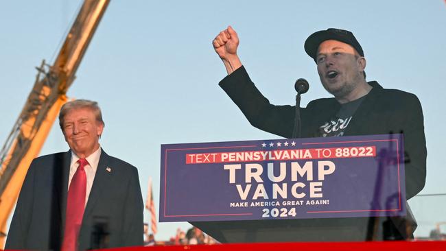 Elon Musk speaks on stage as he joins Donald Trump during a campaign rally.