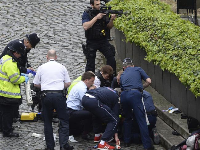 People rush to the aid of one of the victims of the attack.