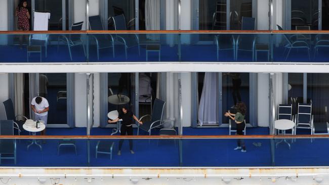 Crew members busy themselves aboard contagious cruise ship Ruby Princess.