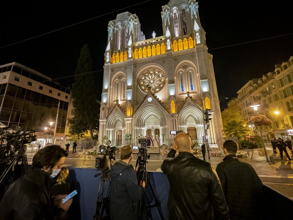 Press stand in front of the Basilica during a mass to pay tribute to the victims on November 01, 2020 in Nice, France. A 21-year-old Tunisian man is accused of fatally stabbing three people in the church on Thursday. Picture: Arnold Jerocki
