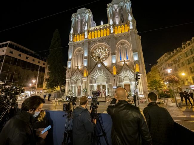 Press stand in front of the Basilica during a mass to pay tribute to the victims on November 01, 2020 in Nice, France. A 21-year-old Tunisian man is accused of fatally stabbing three people in the church on Thursday. Picture: Arnold Jerocki