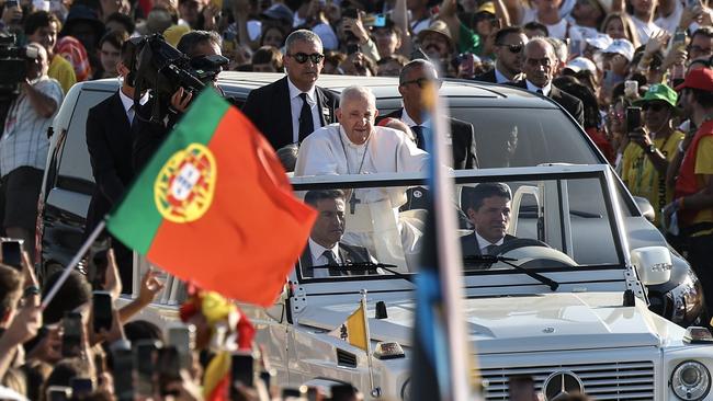 Pope Francis waves to pilgrims as he arrives to attend a Holy Mass on the last day of World Youth Day in Lisbon.