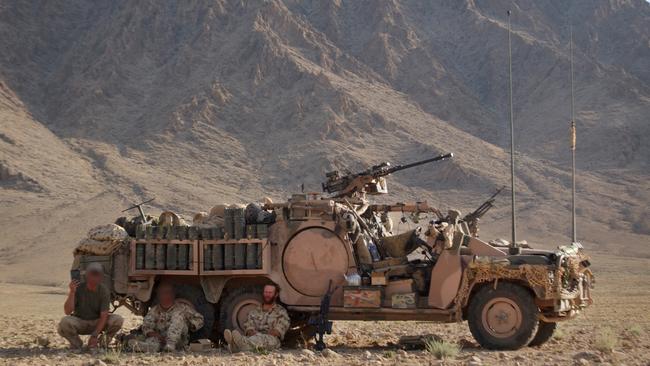 Australian special forces get some respite in the shade of the Long Range Patrol Vehicle near Chora in Afghanistan.