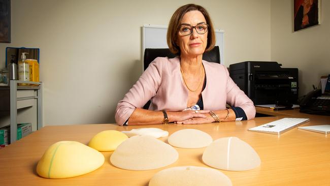 Aesthetic plastic surgeon Associate Professor Gillian Farrell with examples of breast implants. Picture: Mark Stewart