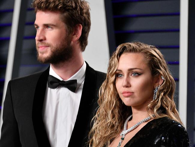 (FILES) In this file photo taken on February 24, 2019 Liam Hemsworth (L) and Miley Cyrus attend the 2019 Vanity Fair Oscar Party hosted by Radhika Jones at Wallis Annenberg Center for the Performing Arts  in Beverly Hills, California. - Pop star Miley Cyrus clapped back at her social media haters on August 22, 2019 over her recent split with longtime partner Liam Hemsworth, an Australian actor, to deny allegations that she cheated on him. "I can accept that the life I've chosen means I must live completely open and transparent with my fans who I love, and the public, 100% of the time. What I cannot accept is being told I'm lying to cover up a crime I haven't committed. I have nothing to hide," the 26-year-old superstar tweeted. (Photo by Dia Dipasupil / GETTY IMAGES NORTH AMERICA / AFP)