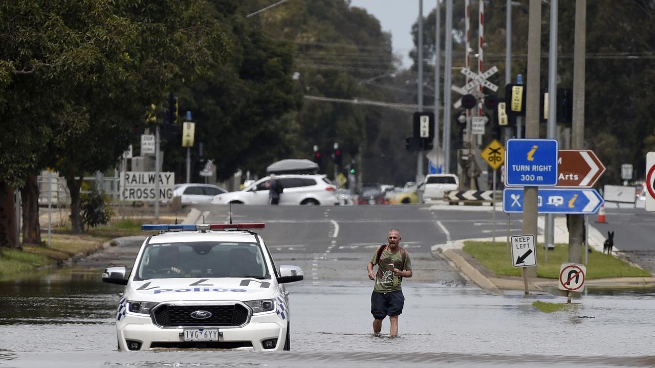 A police car patrols along the submerged Wyndham St in Shepparton. Picture: NCA NewsWire / Andrew Henshaw Picture: NCA NewsWire / Andrew Henshaw